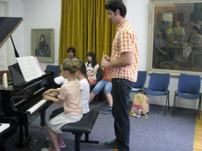 Jure Rozman teaching young pianists in Music School in St. Stanislavs' Instiutiton